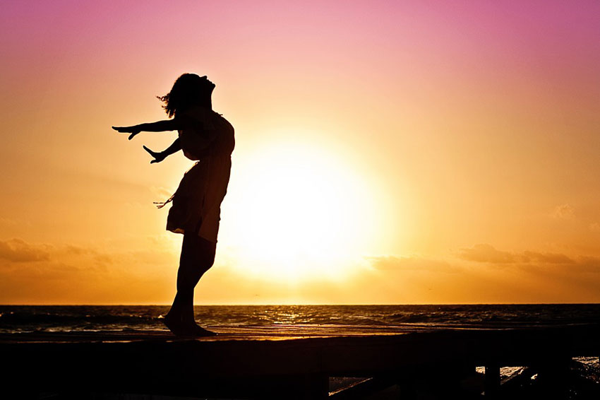 woman at sunset by the beach