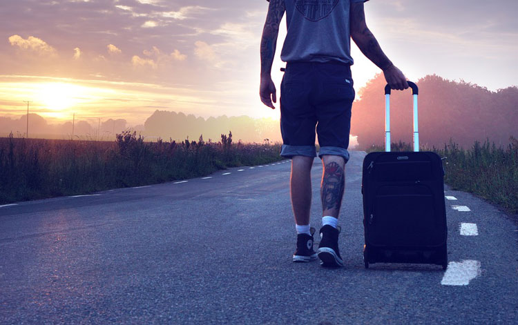 guy with a suitcase on the highway