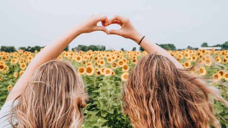 Healthy friendship with healthy boundaries between two women in a flower field