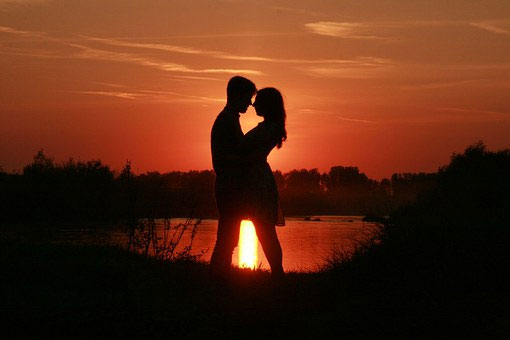 Man and woman embracing at sunset