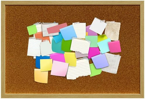Blank post it notes on a bulletin board for setting healthy goals