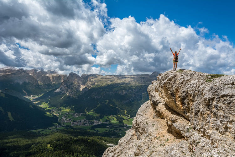 Person on top of a mountain arms spread wide