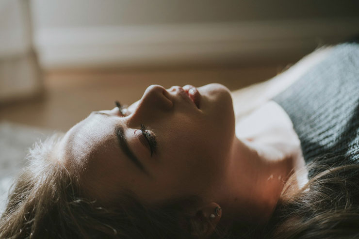 Woman lying down in relaxed hypnotic state