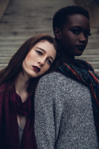 A depressed woman leaning her head on her friend’s shoulder