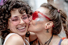 A couple kissing during a Pride event.