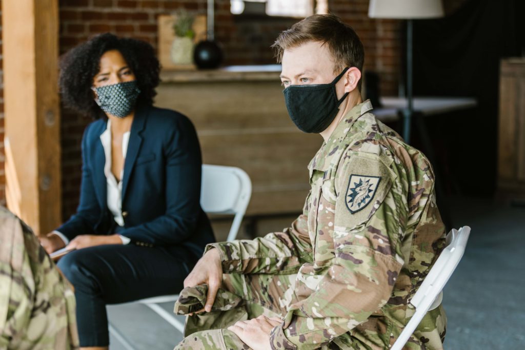 Psychologist listening to soldiers in a therapy session