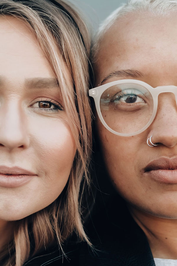 Two people's faces side by side looking out at camera