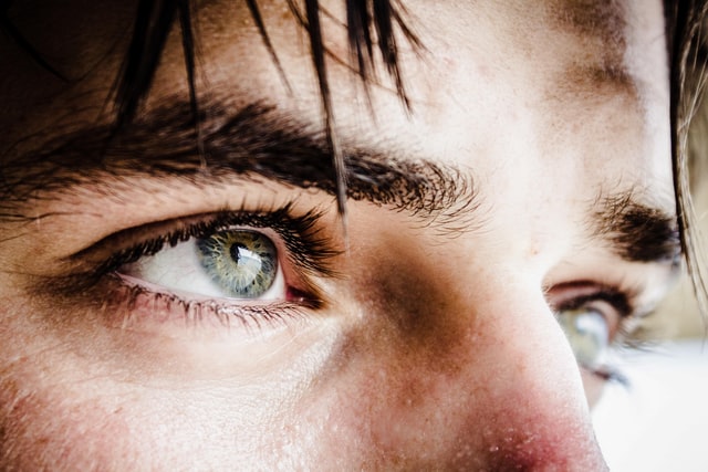 Close up of a man's eyes looking up