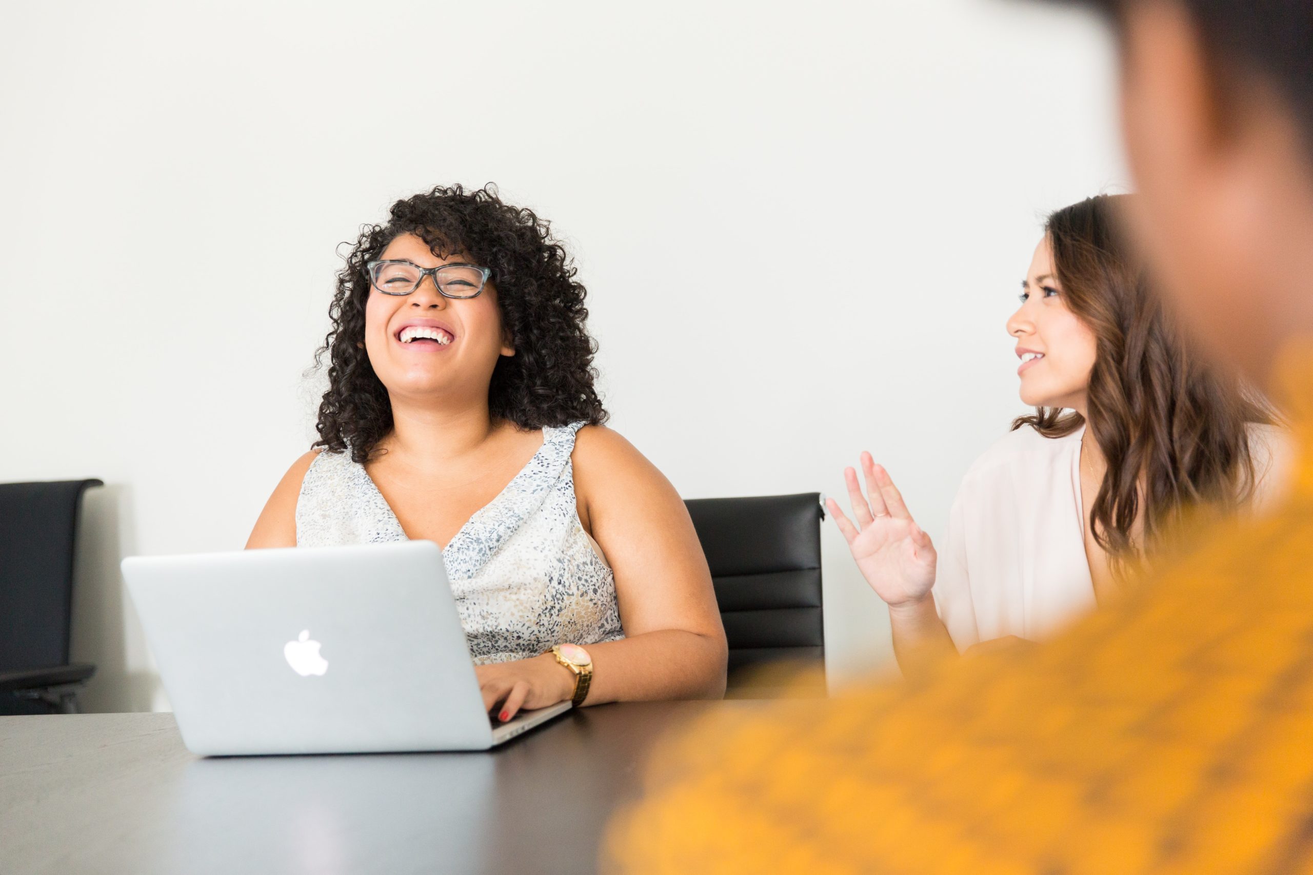 Smiling teammates at a workplace meeting