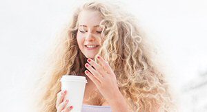 woman smiling drinking coffee