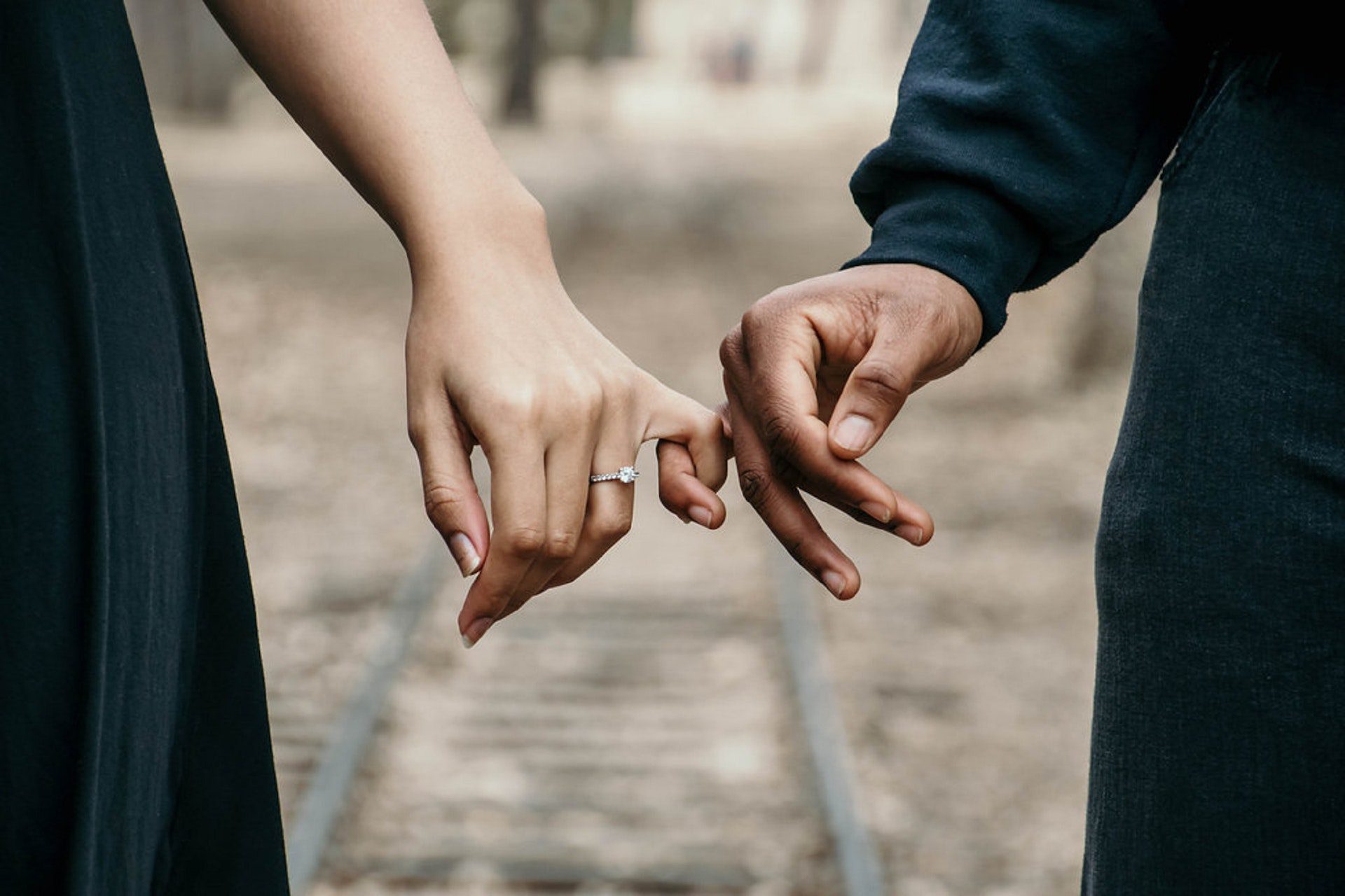 Engaged couple with linked fingers