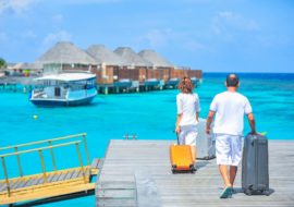 Man and woman docking to vacation villas for a mental health boost
