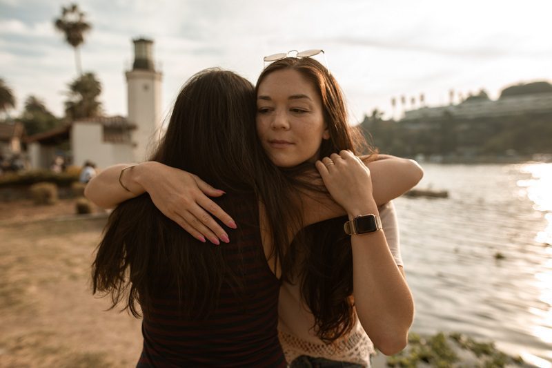 Two women hugging each other