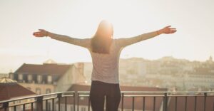 Happy woman with arms outstretched after therapy for phobias