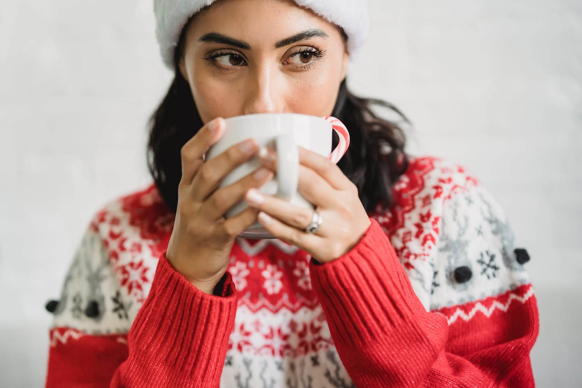 A woman sipping a drink