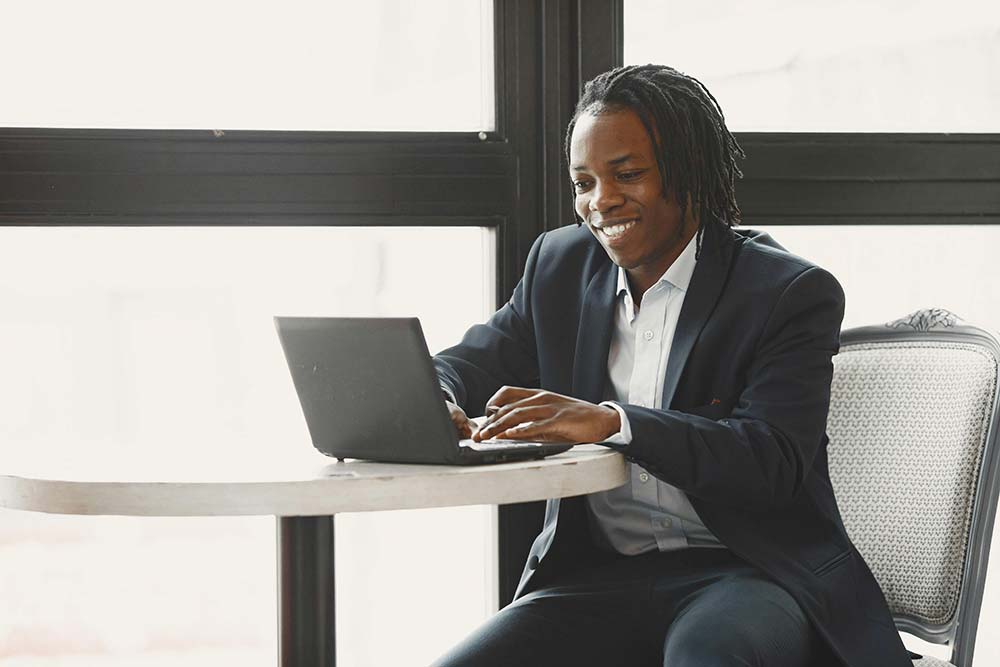A man uses a laptop for a virtual integrative psychotherapy session